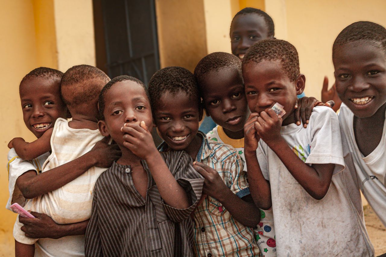 A group of happy African children posing together, showcasing friendship and joy.